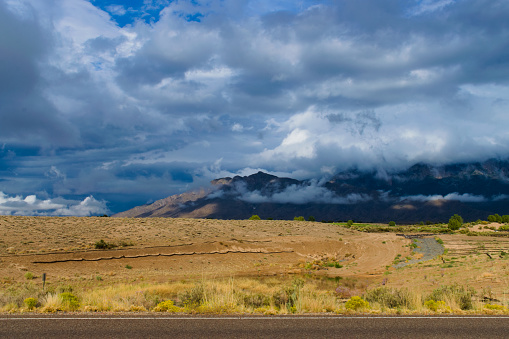 Albuquerque, New Mexico, USA, September 30, 2021- Landscape, clouds envelop the mountains, the desert in the front view.