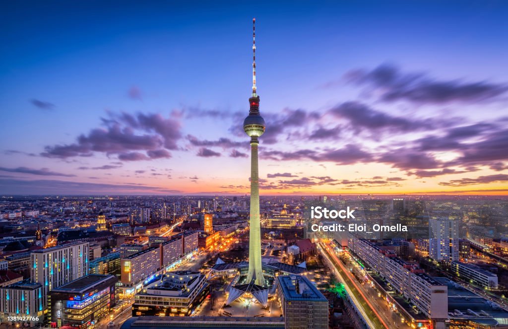 Berlin skyline panorama with famous TV tower at Alexanderplatz. Germany Aerial view of Berlin skyline with famous TV tower at Alexanderplatz and dramatic cloudscape in twilight during blue hour at dusk. Germany Berlin Stock Photo