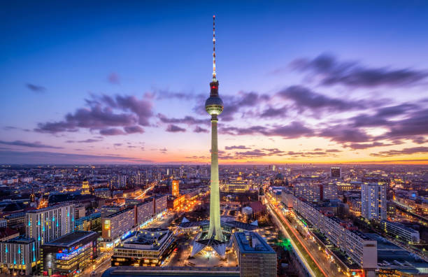 Berlin skyline panorama with famous TV tower at Alexanderplatz. Germany Aerial view of Berlin skyline with famous TV tower at Alexanderplatz and dramatic cloudscape in twilight during blue hour at dusk. Germany east berlin photos stock pictures, royalty-free photos & images