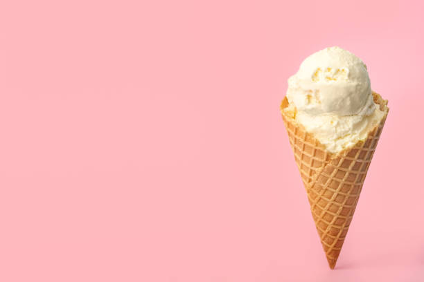istock Delicious ice cream in waffle cone on pink background. Space for text 1381471528