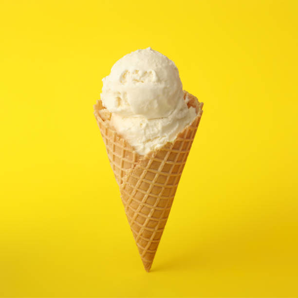 istock Delicious ice cream in waffle cone on yellow background 1381472136