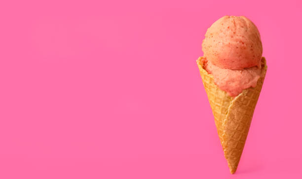 istock Delicious ice cream in waffle cone on pink background. Space for text 1381473240