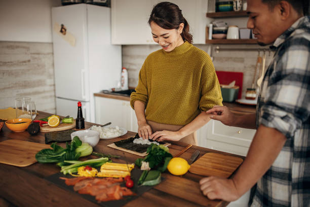 istock Woman preparing sushi 1381474346
