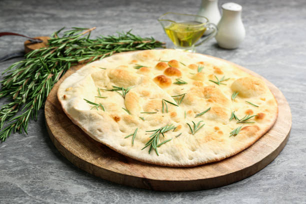 istock Delicious fresh focaccia bread on grey table 1381475432
