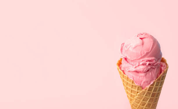 istock Delicious ice cream in waffle cone on pink background, closeup. Space for text 1381475437
