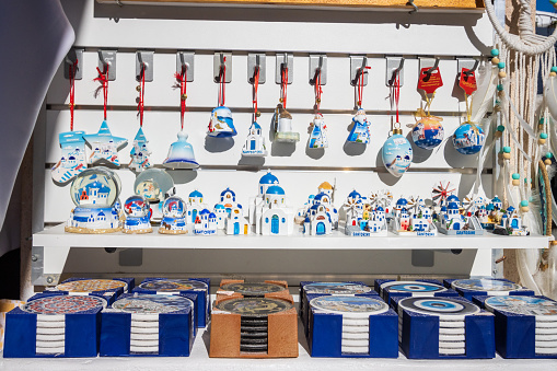 Souvenirs at Gift Shop in Pyrgos Kallistis on South Aegean Sea, Greece. Design elements are visible.