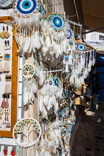 'Evil Eye' (Mati) in Pyrgos Kallistis in Santorini, Greece. Other commercial items are visible in the background. The eye is meant to ward off malicious curses from jealous people.