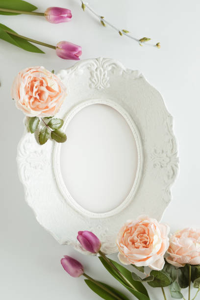 istock Creative arrangement made with white frame and colorful flowers on bright background. Elegant spring visual. Minimal flat lay aesthetic with copy space. 1381484386