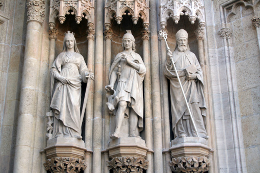 three statues on the facade of the Zagreb Cathedral. The Cathedral on Kaptol is the most famous building in Zagreb, and the tallest building in Croatia. The statues are placed left and right from the main entrance to the Cathedral.