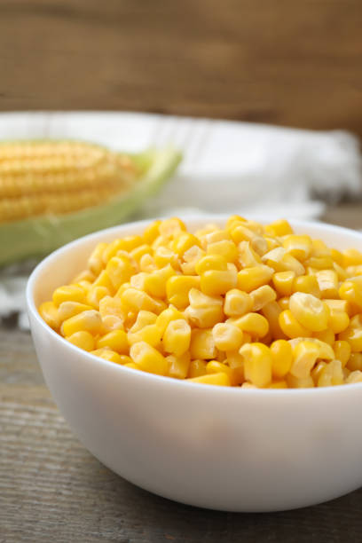 istock Bowl of preserved corn on wooden table 1381489385