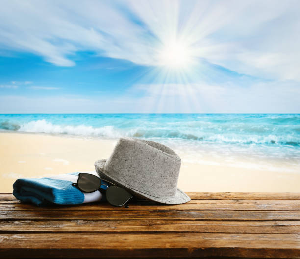 istock Beach accessories on wooden surface near ocean 1381492732