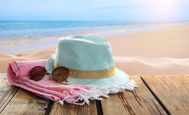 istock Beach accessories on wooden surface near ocean 1381492734