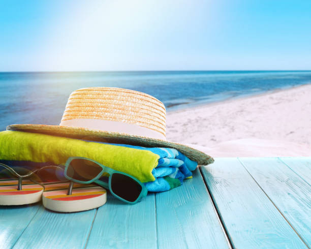 istock Beach accessories on turquoise wooden surface near ocean 1381494324