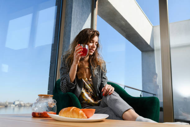 istock Woman drink tea in modern house interior 1381511809