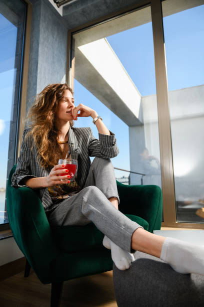 istock Woman drink tea in modern house interior 1381512885