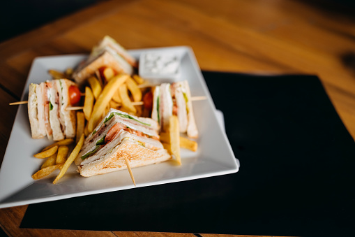 Club sandwich served on white plate in the restaurant