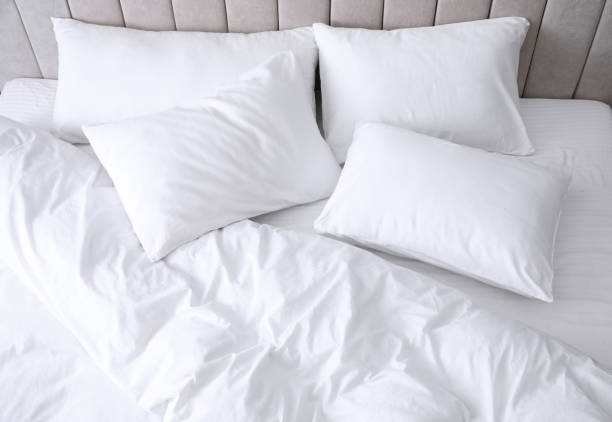 Comfortable bed with soft white pillows, closeup Comfortable bed with soft white pillows, closeup duvet stock pictures, royalty-free photos & images