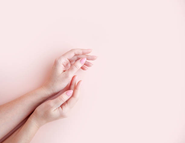 istock well-groomed female hands on a pink background 1381527365
