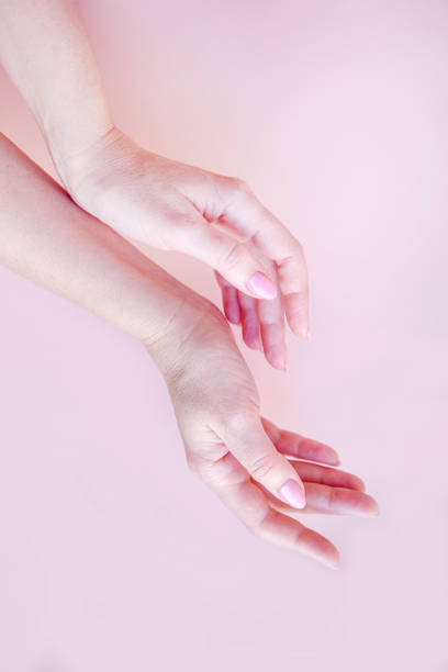 istock well-groomed female hands on a pink background 1381528994
