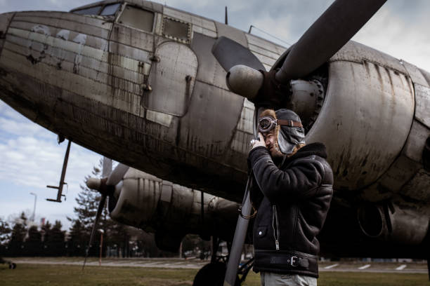 istock A young manposes in an airplane cemeteryas an old-fashioned pilot 1381542357