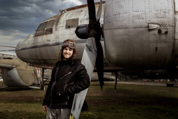 istock A young manposes in an airplane cemeteryas an old-fashioned pilot 1381542370