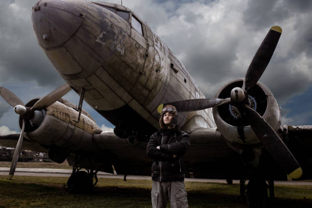 istock A young manposes in an airplane cemeteryas an old-fashioned pilot 1381542372