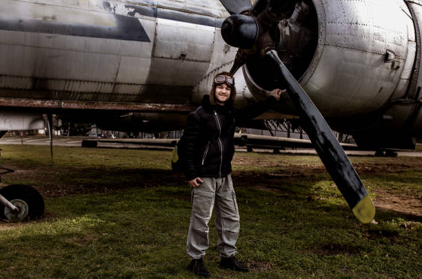 istock A young manposes in an airplane cemeteryas an old-fashioned pilot 1381542376