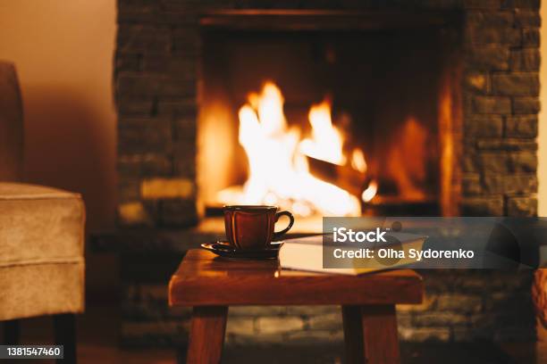 Cup Of Hot Drink In Front Of Warm Fireplace Stock Photo - Download Image Now - Fireplace, Cozy, Log Cabin