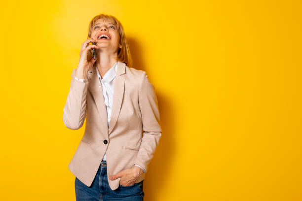 istock Woman speaking on the phone and laughing 1381552502