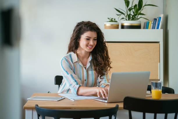 istock Happy Businesswoman Using a Laptop Computer at Home 1381568386