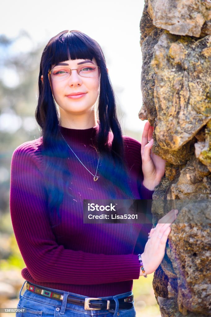 Outdoor portrait of beautiful real university age generation z young woman with septum piercing and individual style living with alopecia Beautiful young woman who wears a wig and false eyebrows/lashes due to hair loss from alopecia Adult Stock Photo