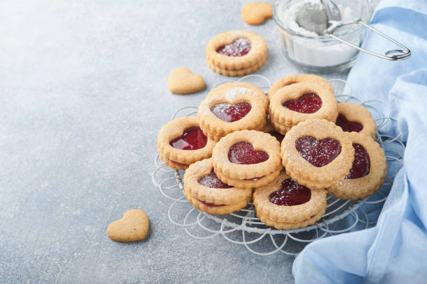 istock Traditional Linzer cookie with strawberry jam and powder sugar on light grey beautiful background. Top view. Traditional homemade Austrian sweet dessert food on Valentines Day. Holiday snack concept. 1381572073