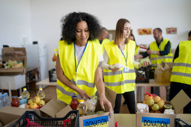 Charity workers preparing food donation boxes for Ukrainian people stock photo