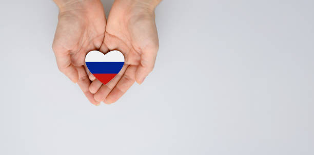 The national flag of Russia (Russian Federation) of arms in female hands. The national flag of Russia (Russian Federation) of arms in female hands. Flat lay, copy space. national anthem stock pictures, royalty-free photos & images
