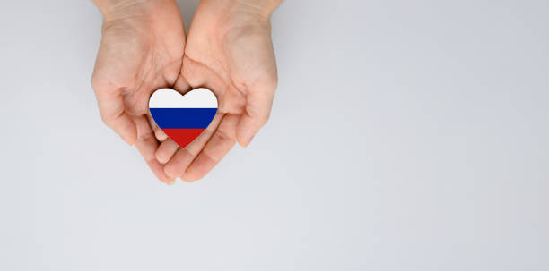 the national flag of russia (russian federation) of arms in female hands. - federation imagens e fotografias de stock