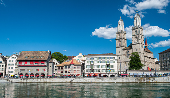 aerial view drone footage of the famous Zurich along the Limmat river international  landmarks such as the Grossmunster cathedral and the lake bridge in Switzerland largest city.