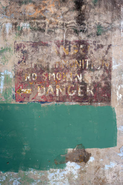 istock dirty weathered concrete wall with the word danger 1381592777