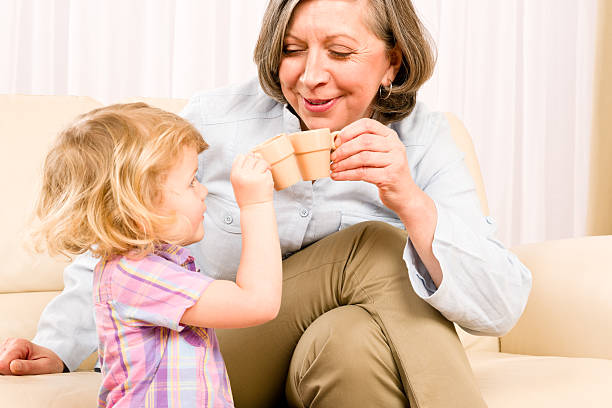 istock Grandmother with granddaughter drink tiny cups 138161550