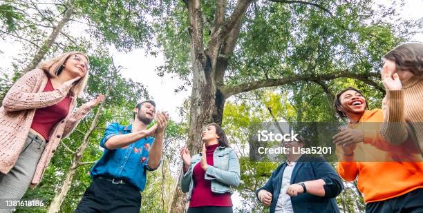 Diverse Happy Group Of Young People Laughing Clapping And Singing Outdoors Youth Group Or Club Or Maybe Team Building Stock Photo - Download Image Now