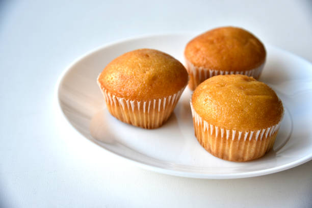 istock Sweet fluffy muffin buns on a white plate 1381638434