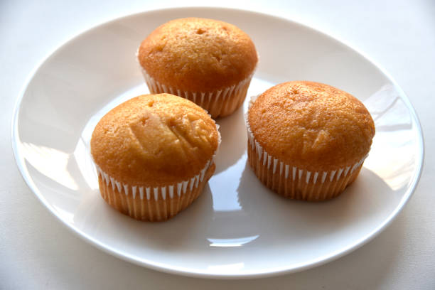 istock Sweet fluffy muffin buns on a white plate 1381638435