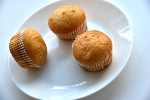 istock Sweet fluffy muffin buns on a white plate 1381638448