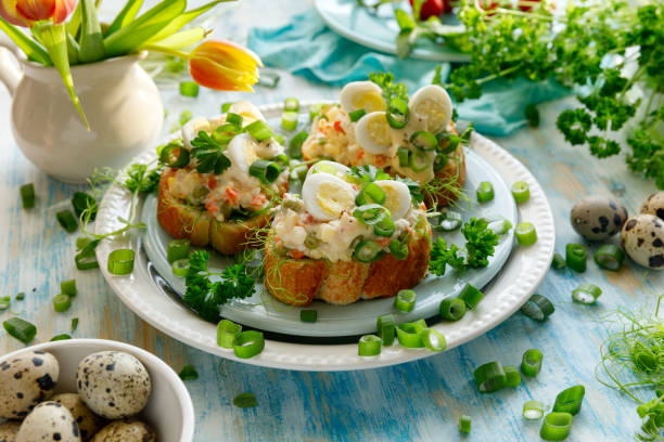 Sandwiches with the addition of traditional vegetable salad, quail eggs and fresh green onion Spring sandwiches with the addition of traditional vegetable salad, quail eggs and fresh green onions. An idea for an Easter breakfast quail egg stock pictures, royalty-free photos & images