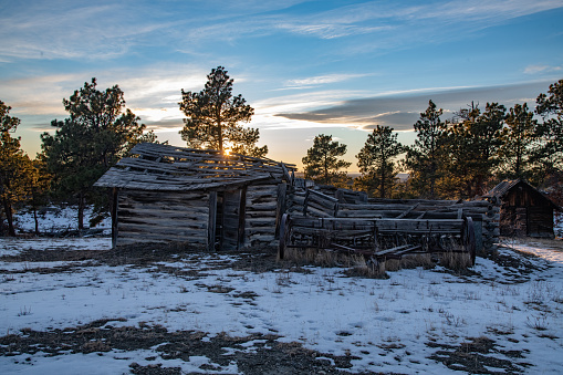 Montana ranch scene at dusk with 100 year old log cabin in central Montana in northwestern United States of America (USA). Nearest big cities are Bozeman and Billings, Montana. John Morrison Photographer