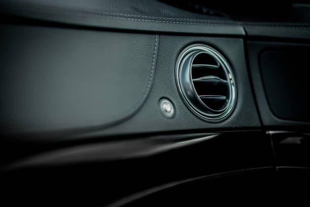 istock Passenger side ventilation in a modern car. Visible round orifice for ventilation of side window in a leather  dashboard in a luxury car. 1381647322