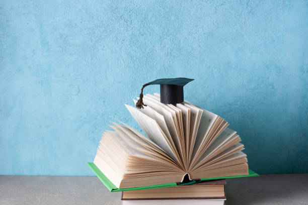 istock student paper cap lies on an open book 1381648929