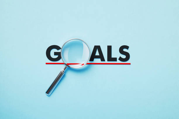 istock Magnifier Forming Goals Word On Blue Background 1381661664