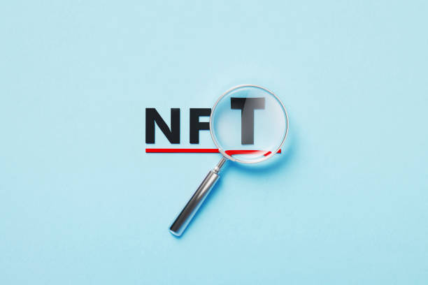 istock Magnifier Forming NFT Abbreviation On Blue Background 1381661689
