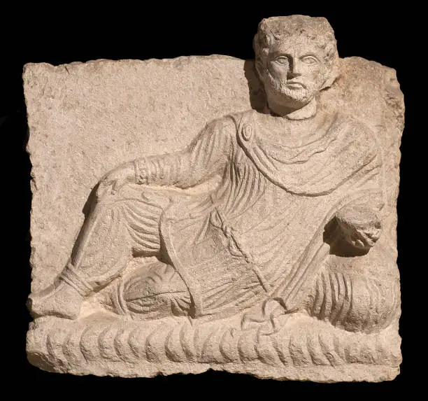 Photo of Resting man - ancient bas relief of Grave funerary Stele from Aydin, Turkey. Roman period, 200-273 AD