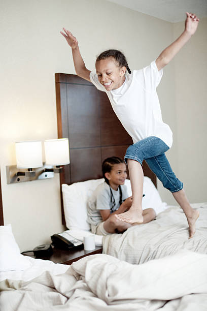 istock kids bed jumping in hotel room 138167257